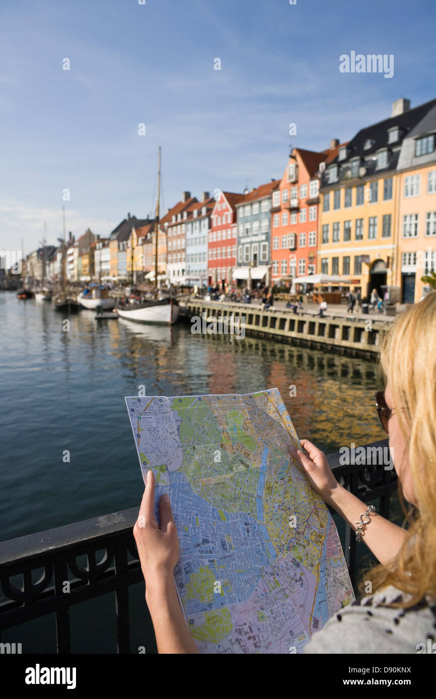 Female tourist reading map at waterfront Stock Photo