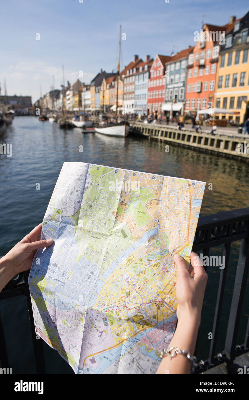 Female tourist holding map at waterfront Stock Photo