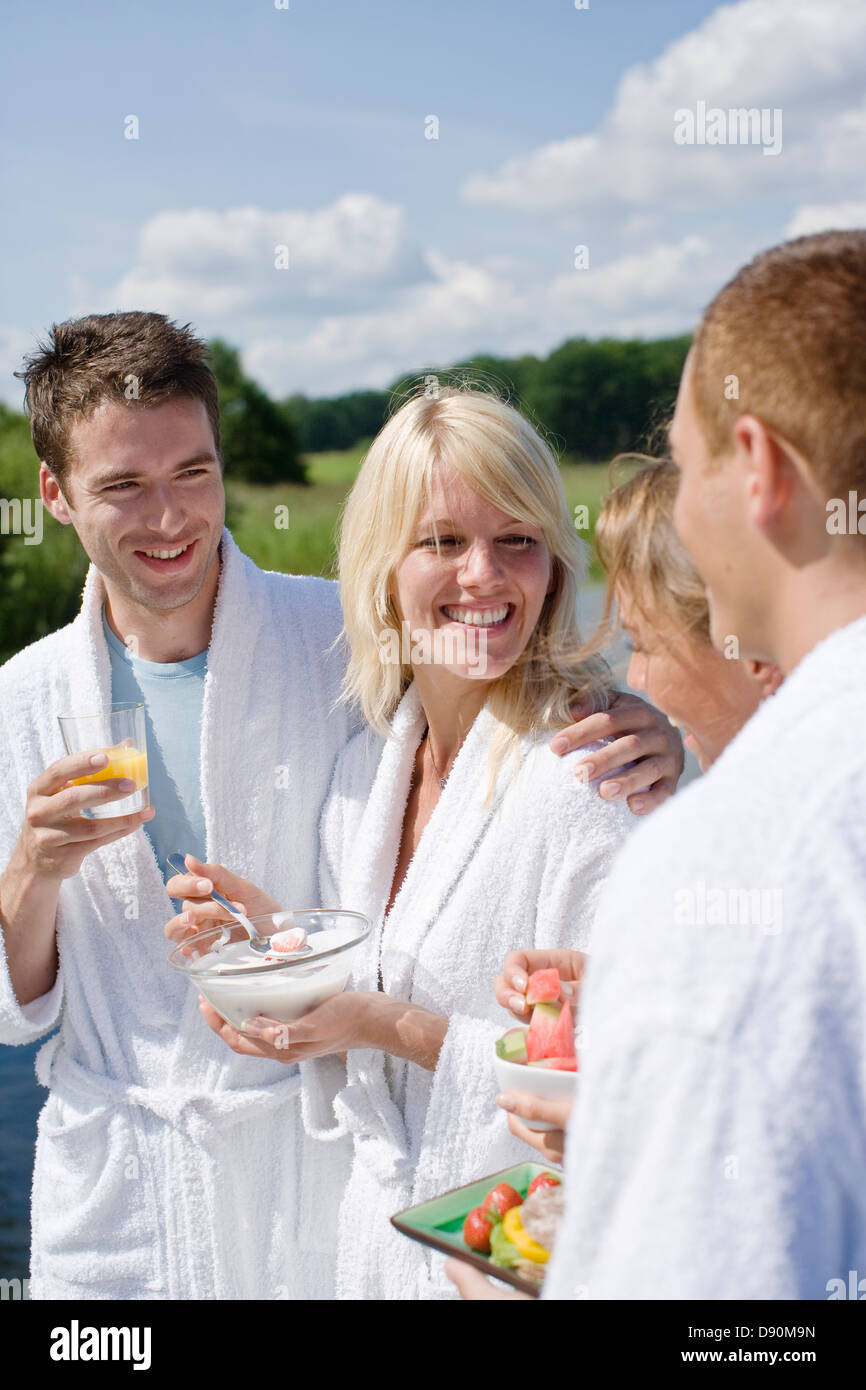 Couples in bathrobe having breakfast, smiling Stock Photo - Alamy