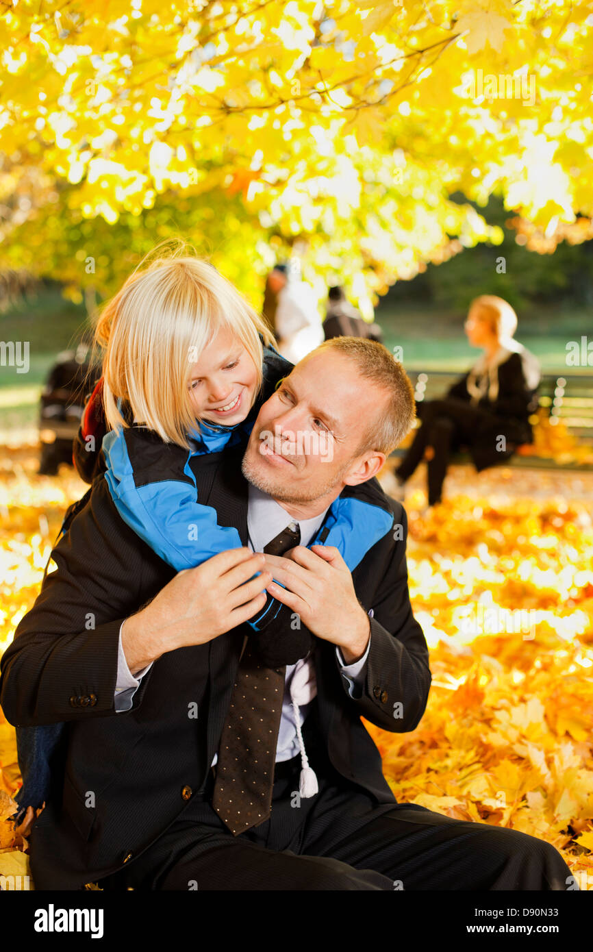 Father and son playing with son in autumn park Stock Photo