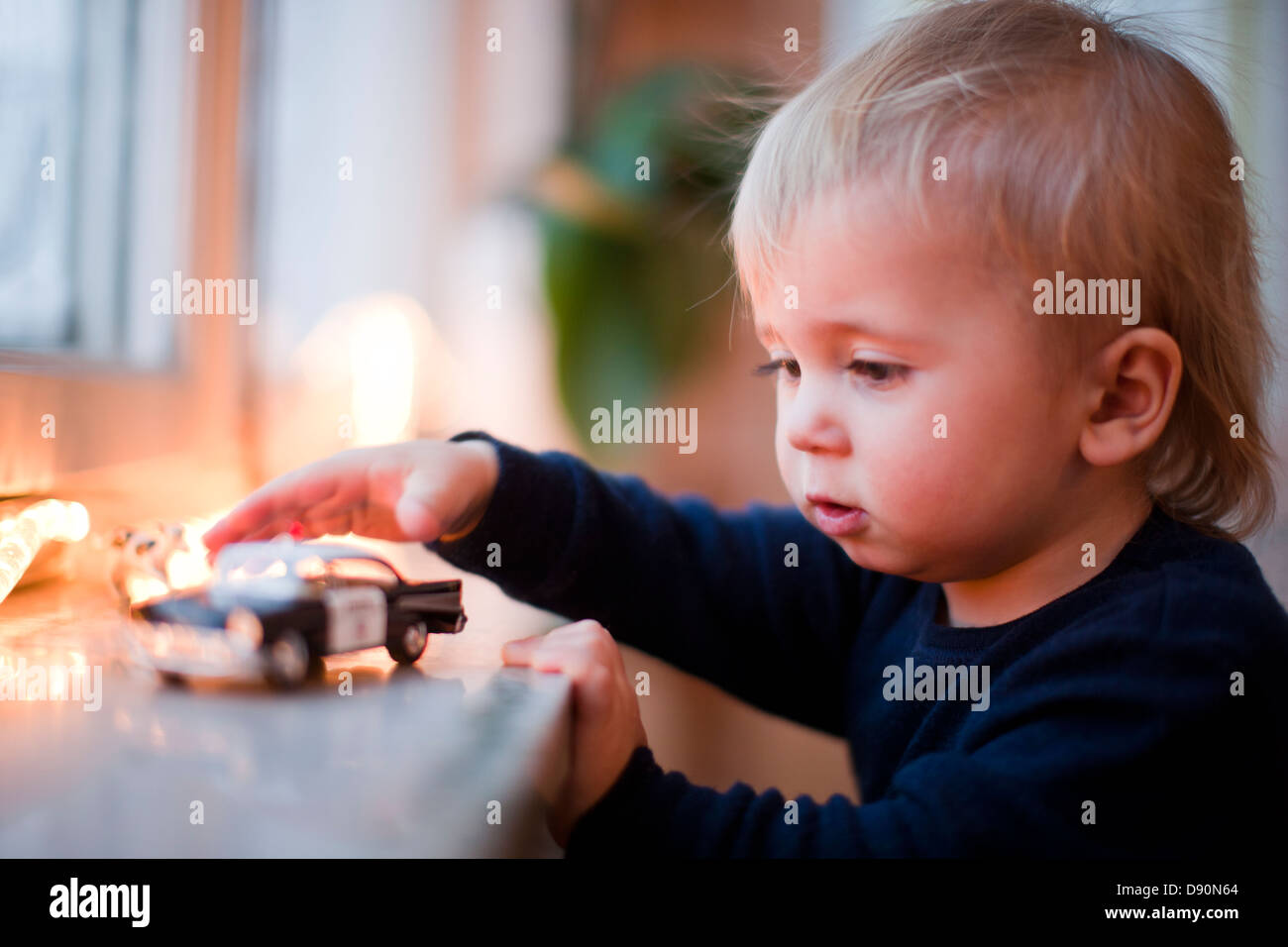 Boy playing with toy car Stock Photo - Alamy
