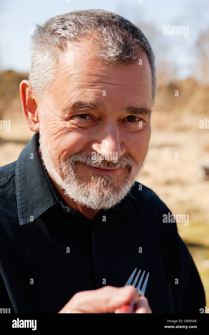 Senior man in black shirt hi-res stock photography and images - Alamy