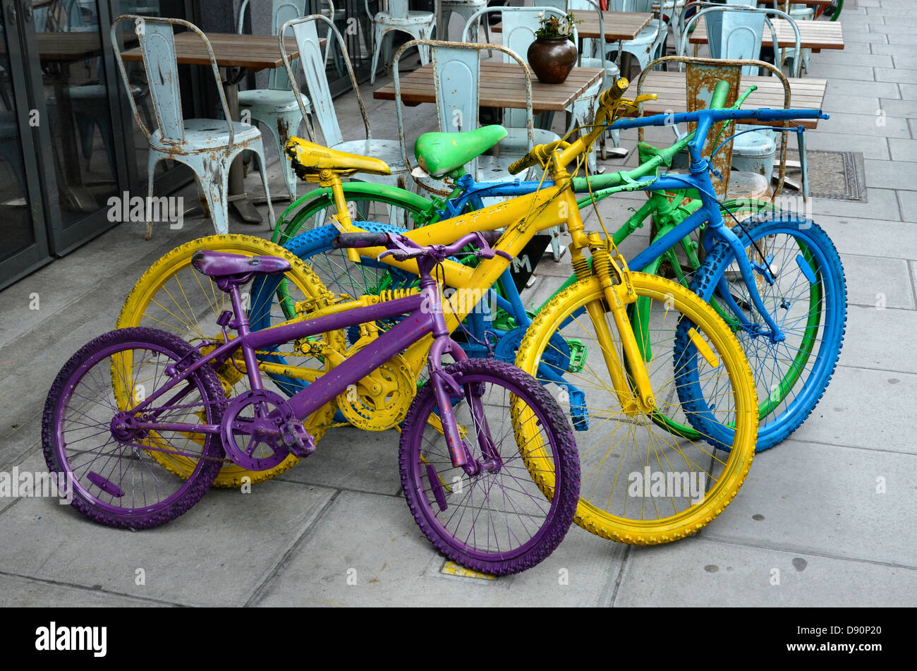 Colourful bicycles help to advertise Dishoom, a restaurant in Upper St Martin’s Lane in the Covent Garden area of London. Stock Photo