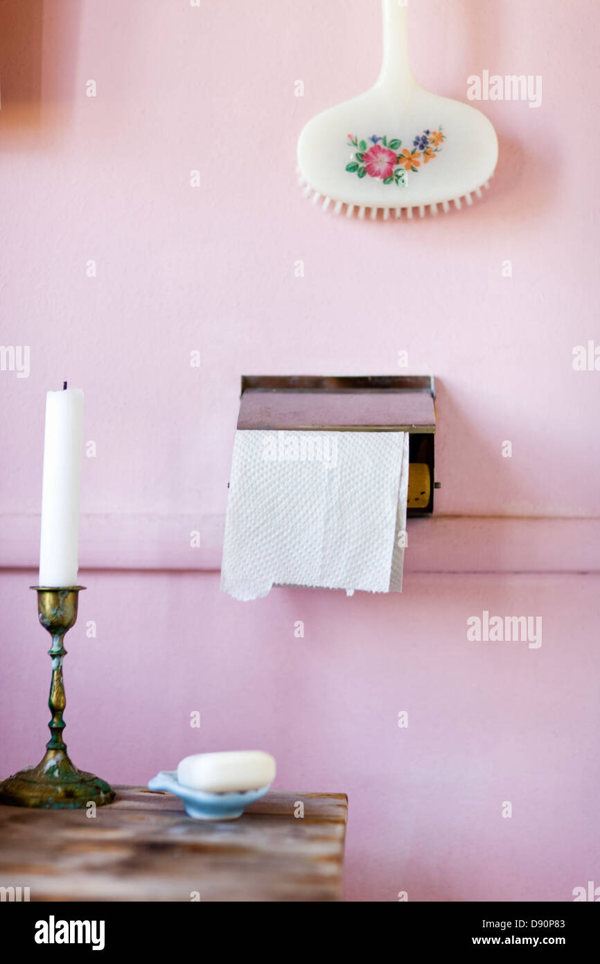 Outhouse toilet paper beside candle Stock Photo Alamy