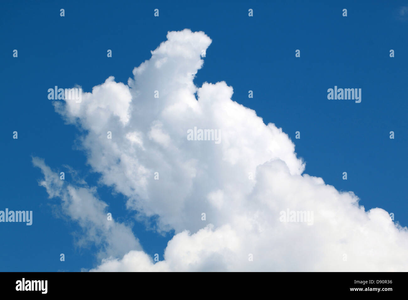 Large bulbous cumulus cloud formation on a sunny day with bright blue sky Stock Photo