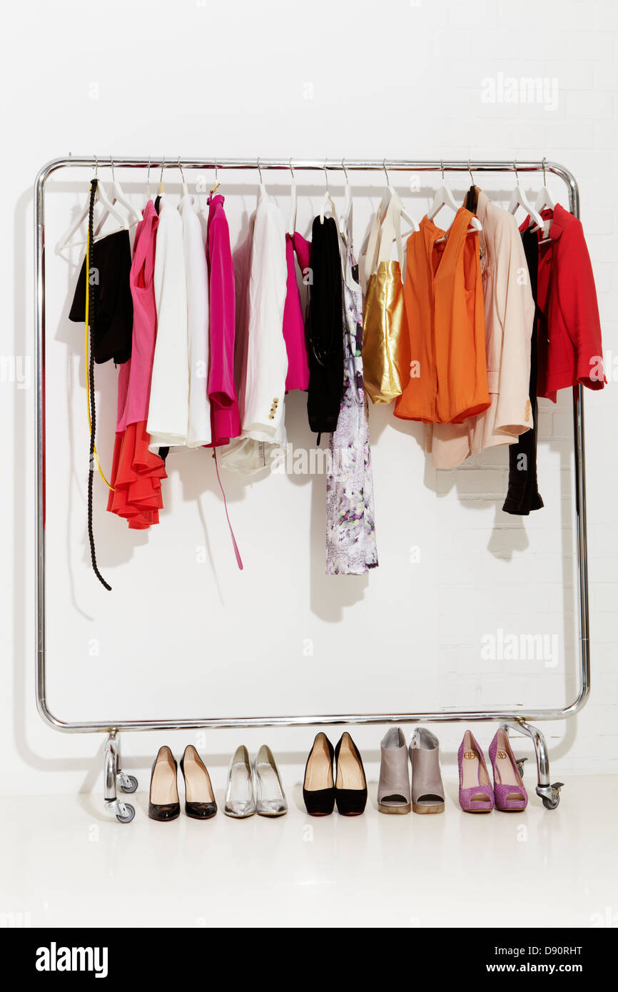 https://c8.alamy.com/comp/D90RHT/clothing-rail-with-pairs-of-footwear-on-white-bakcground-D90RHT.jpg