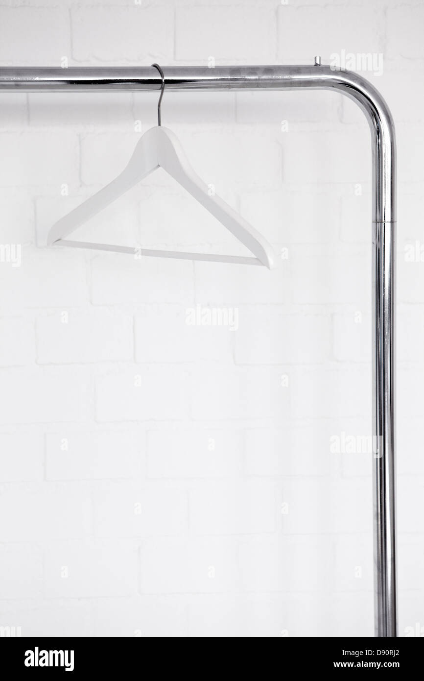 Clothes hanger hanging on clothes rail Stock Photo Alamy