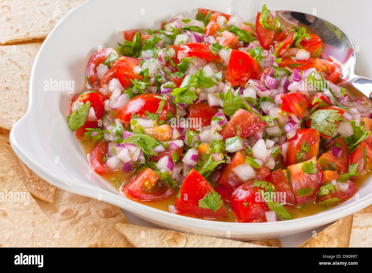 Pico de gallo, or salsa fresca, is a fresh, uncooked relish in Mexican cuisine, made from tomatoes, red onion, Stock Photo