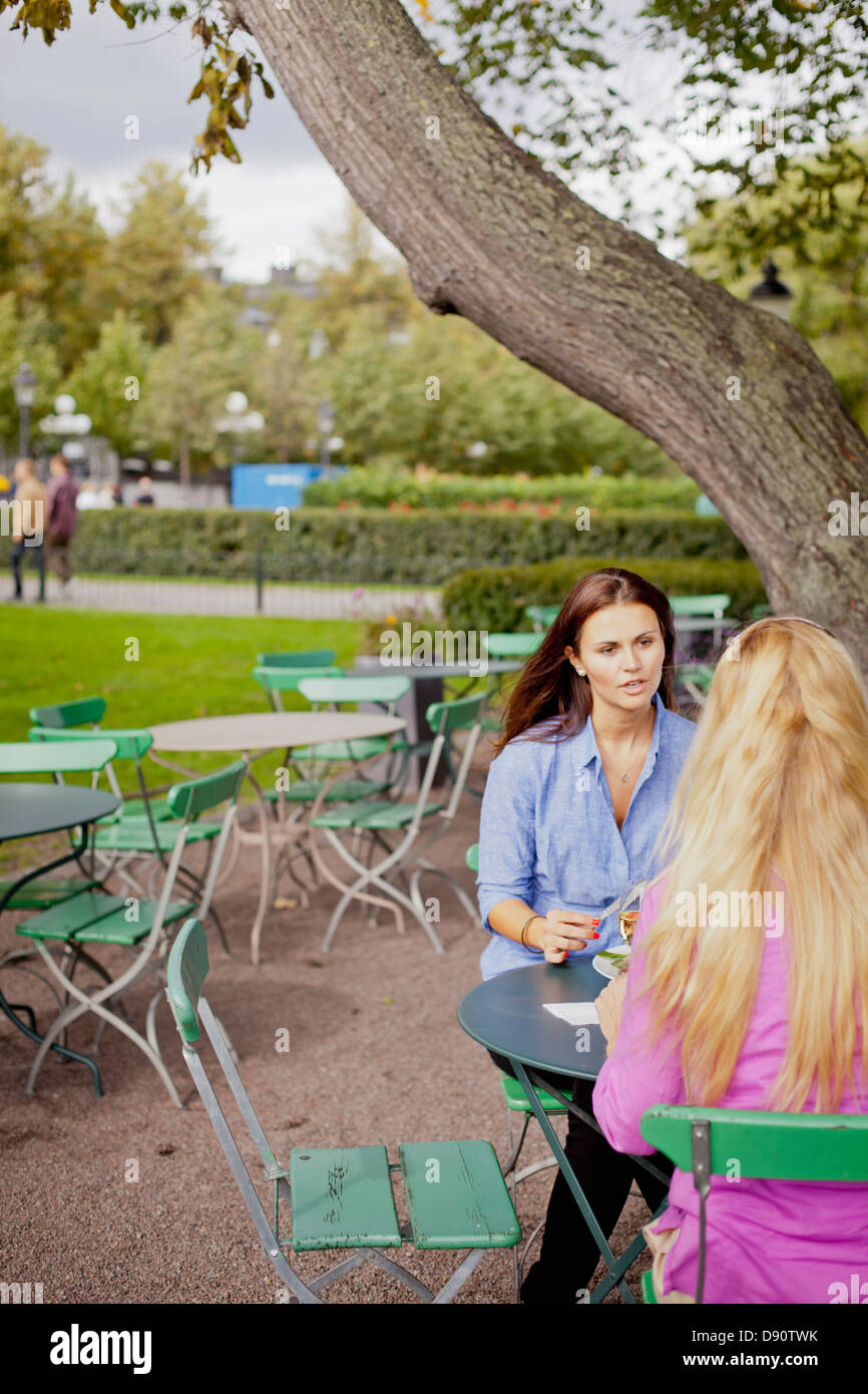 Two women in park sitting hi-res stock photography and images - Alamy