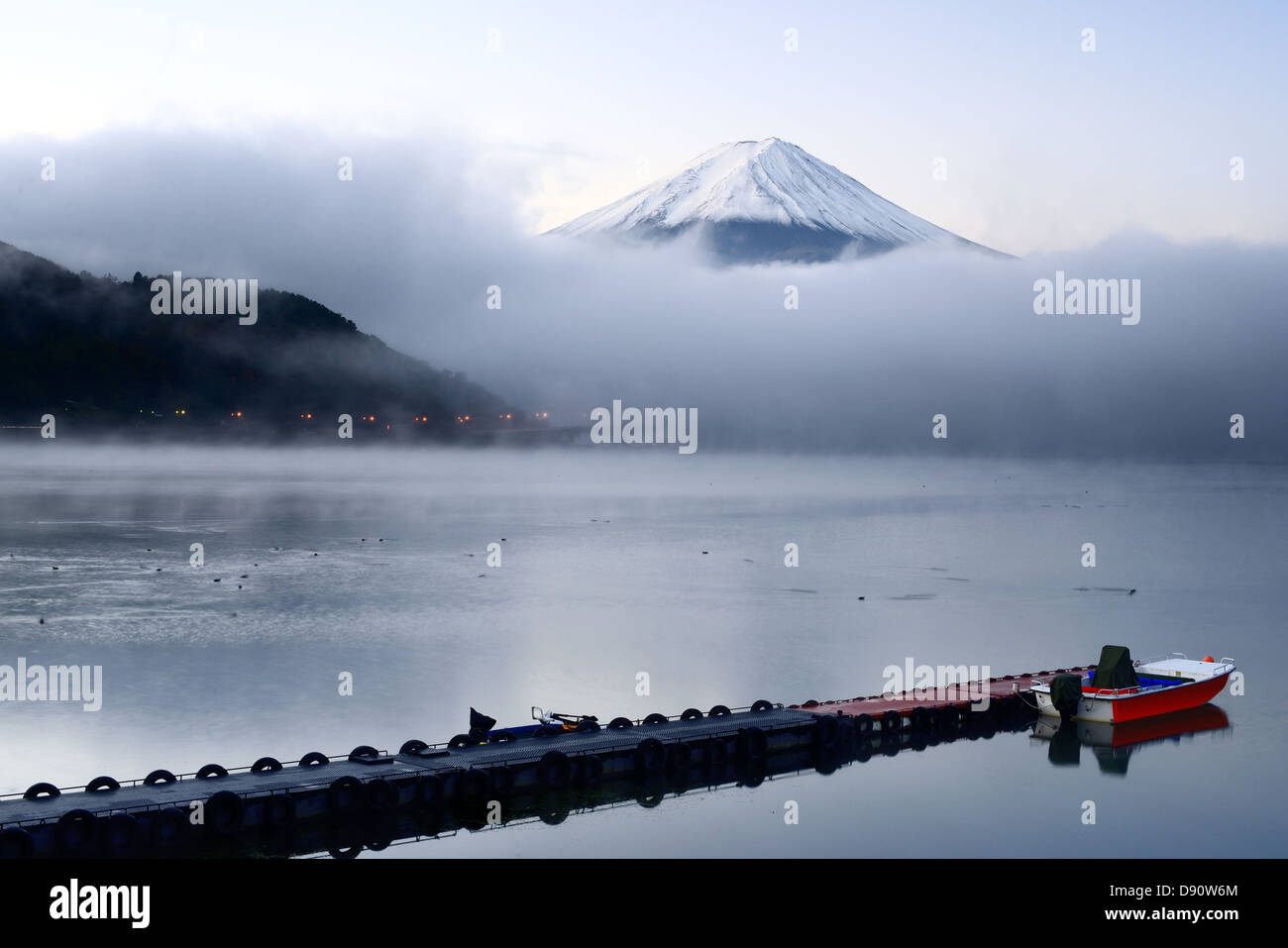 Mt. Fuji peaks from the clouds over Kawaguchi Lake in Japan. Stock Photo