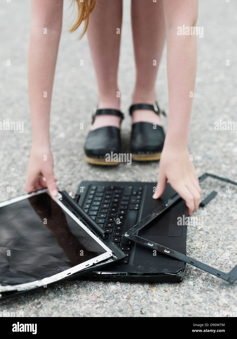 Girl with broken laptop Stock Photo