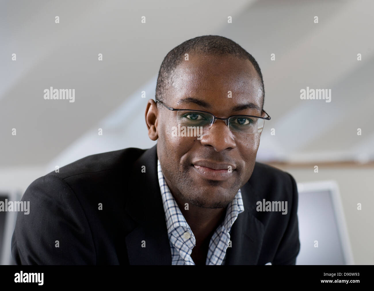 Portrait of smiling young man in office Stock Photo - Alamy