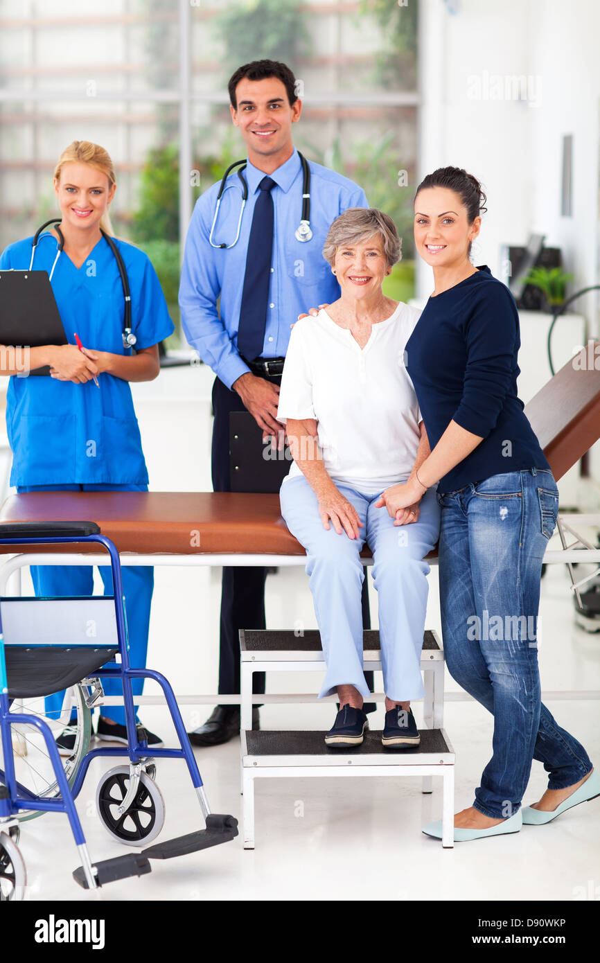 caring daughter taking senior mother for checkup in doctor's office Stock Photo