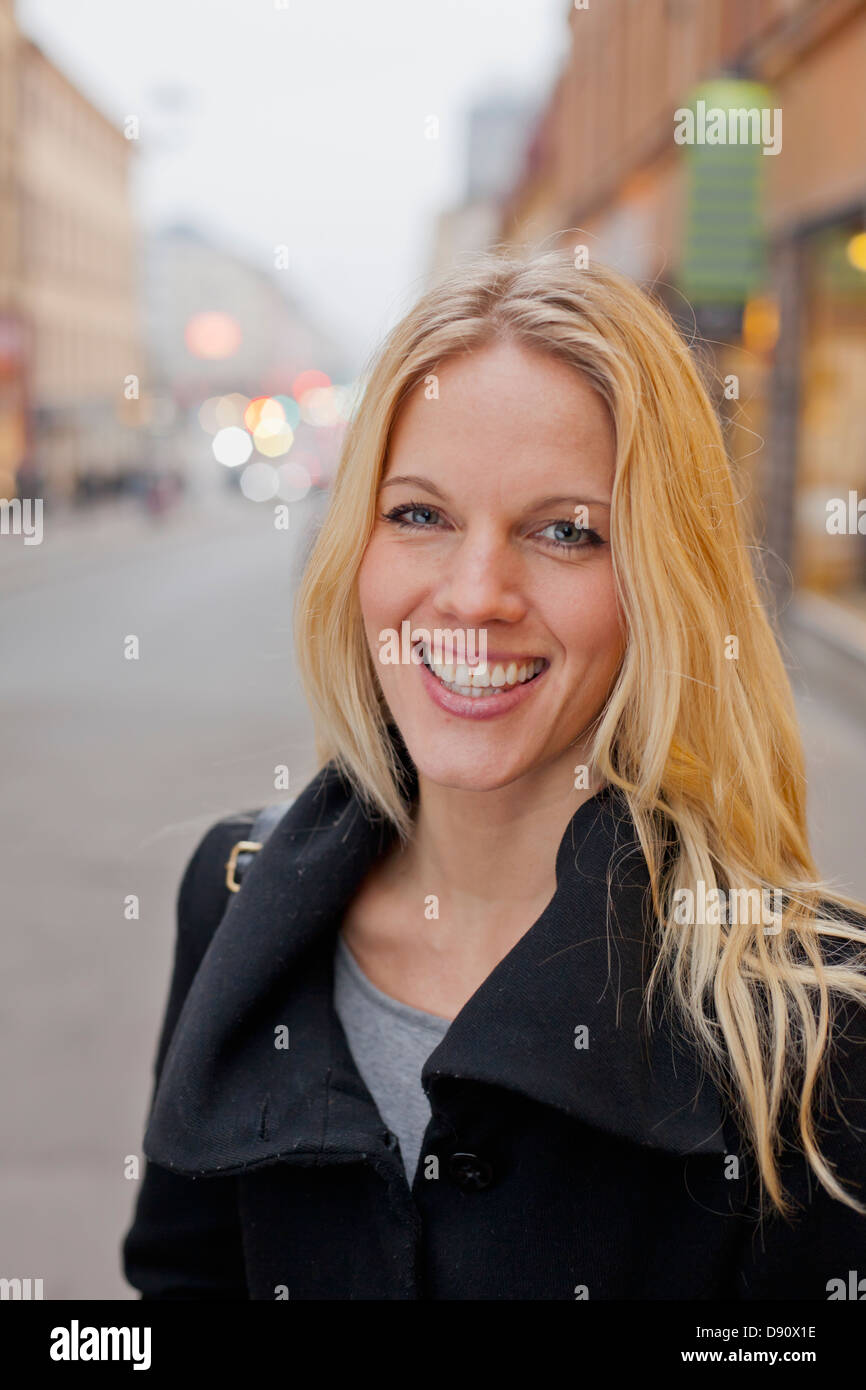 Portrait of woman smiling outdoors Stock Photo - Alamy