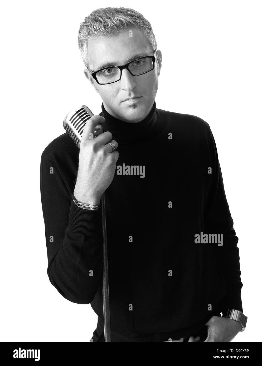Stylish young man posing with old-fashioned microphone Stock Photo