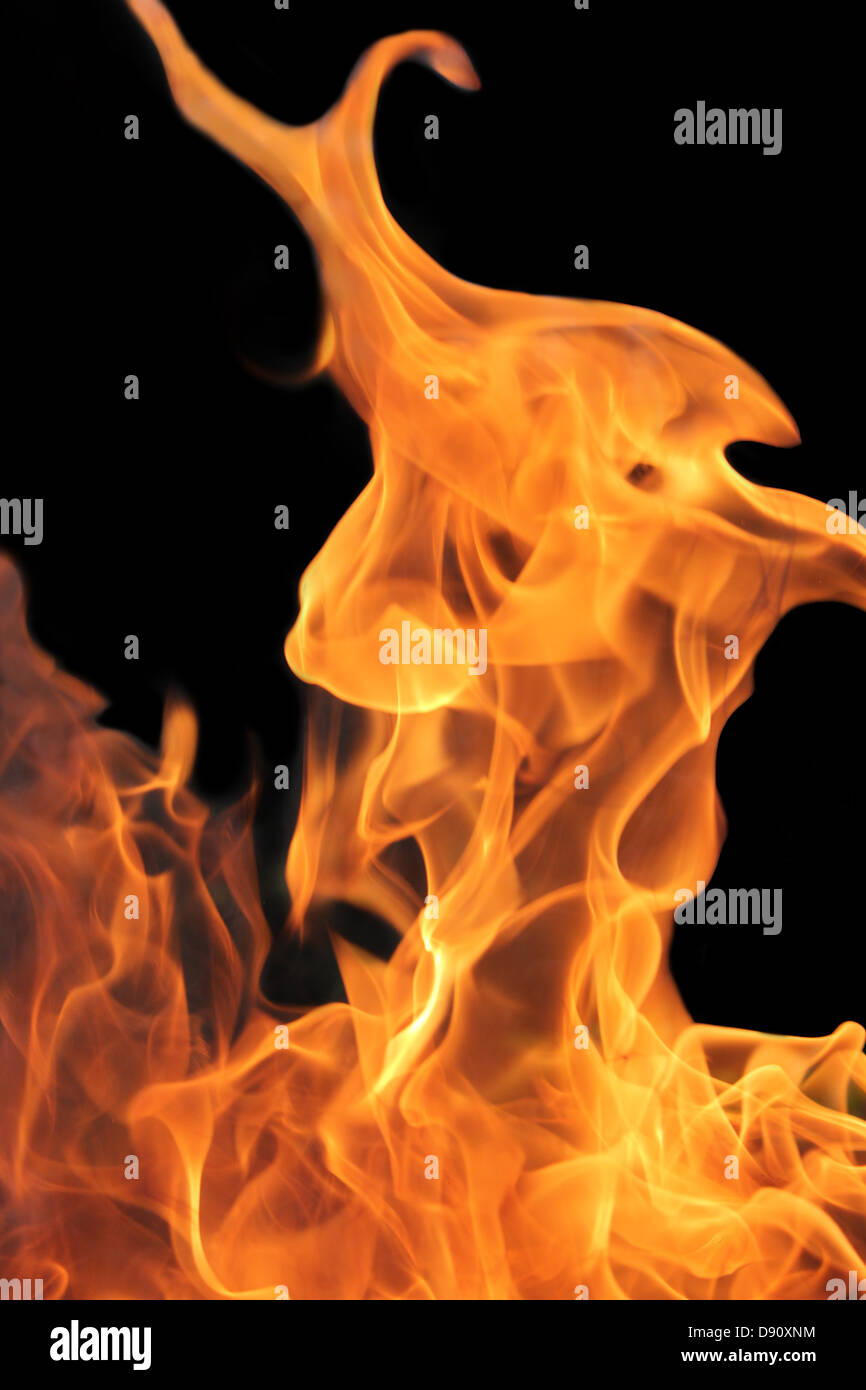 bright Orange flames with a dark background Stock Photo