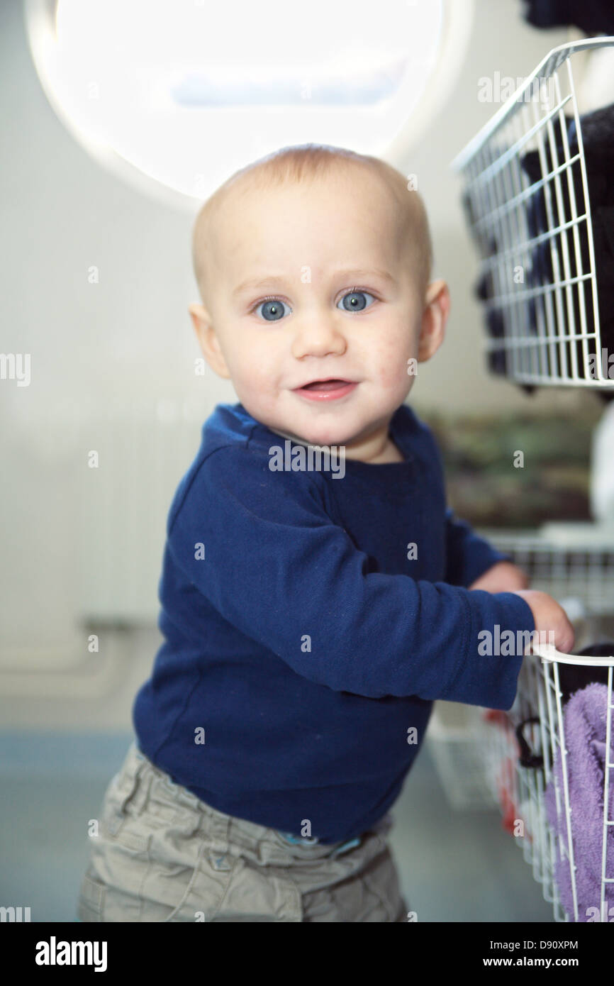 Baby boy trying to stand Stock Photo Alamy