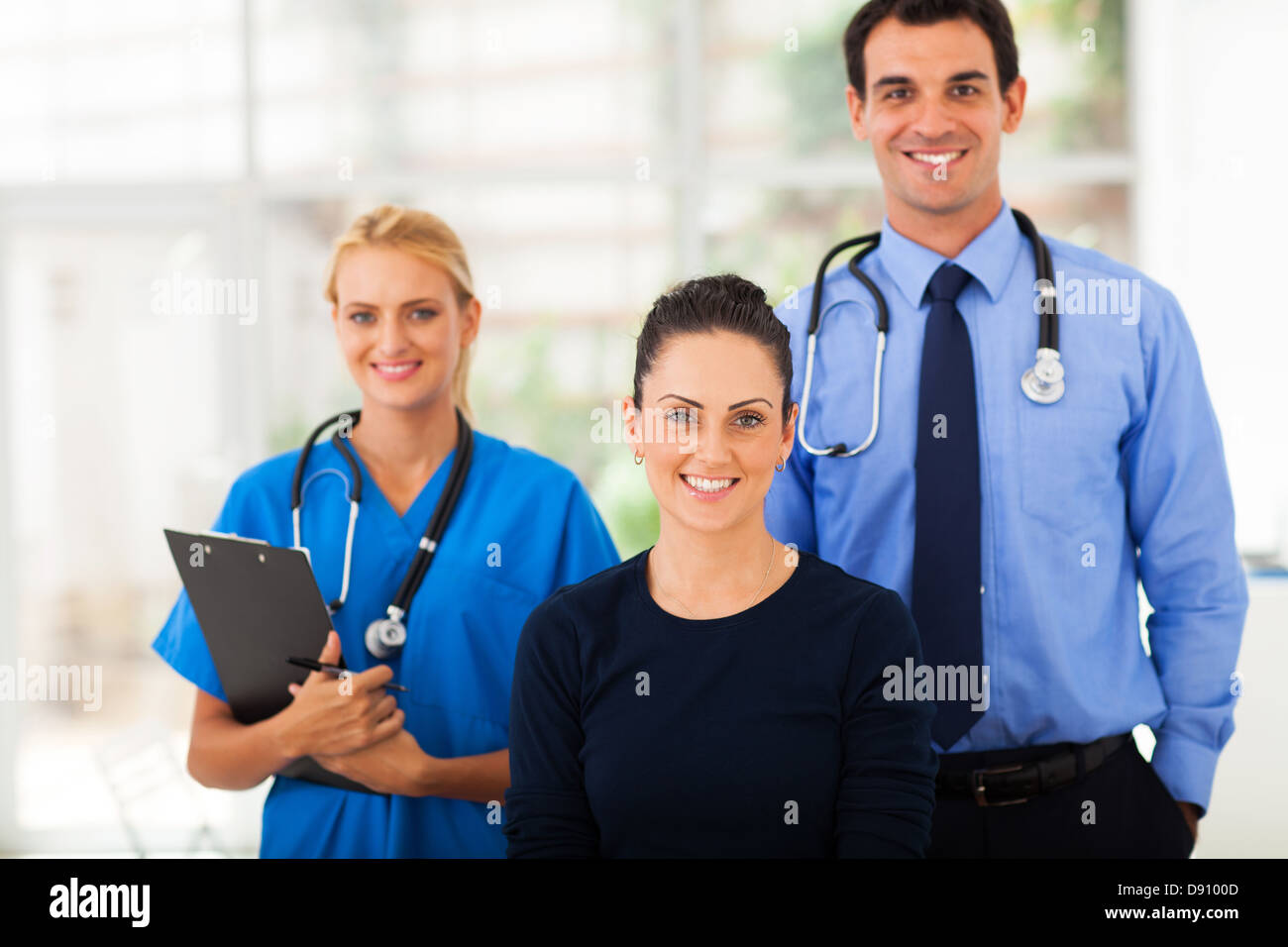 portrait of woman with health workers in hospital Stock Photo