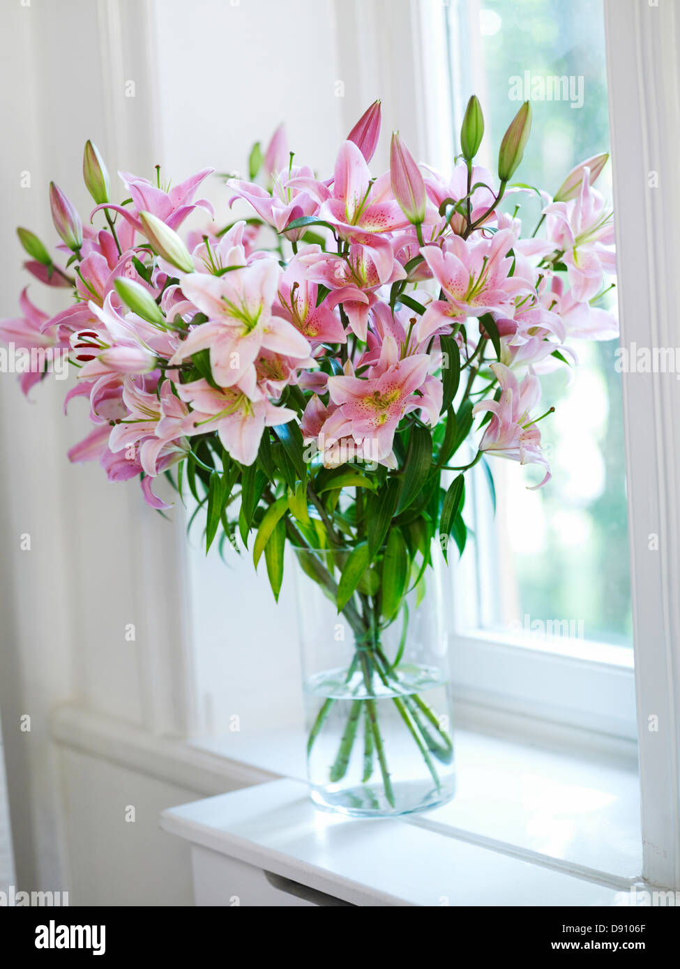 Bouquet of flowers on window sill Stock Photo - Alamy