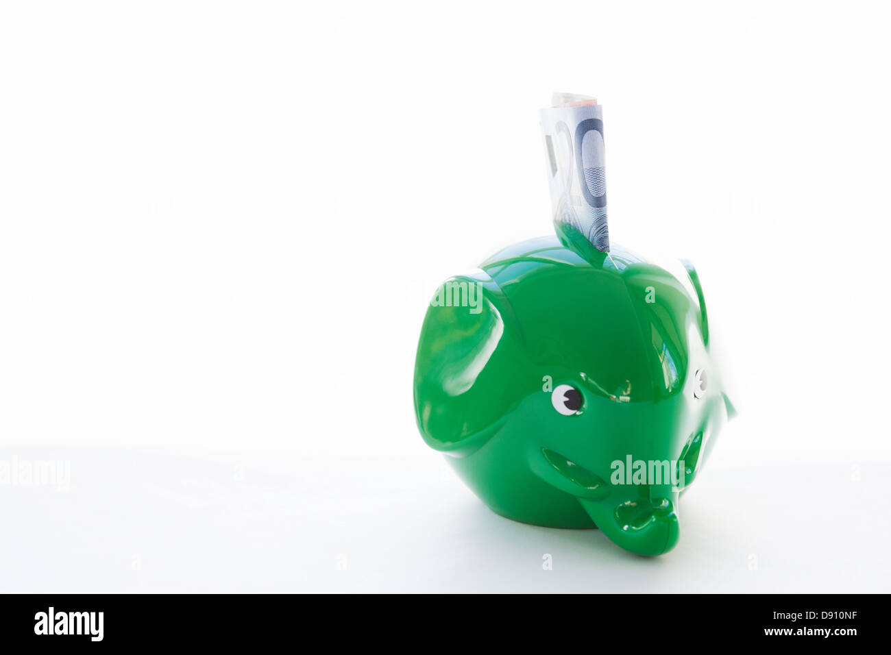 Elephantshaped piggy bank with money Stock Photo Alamy