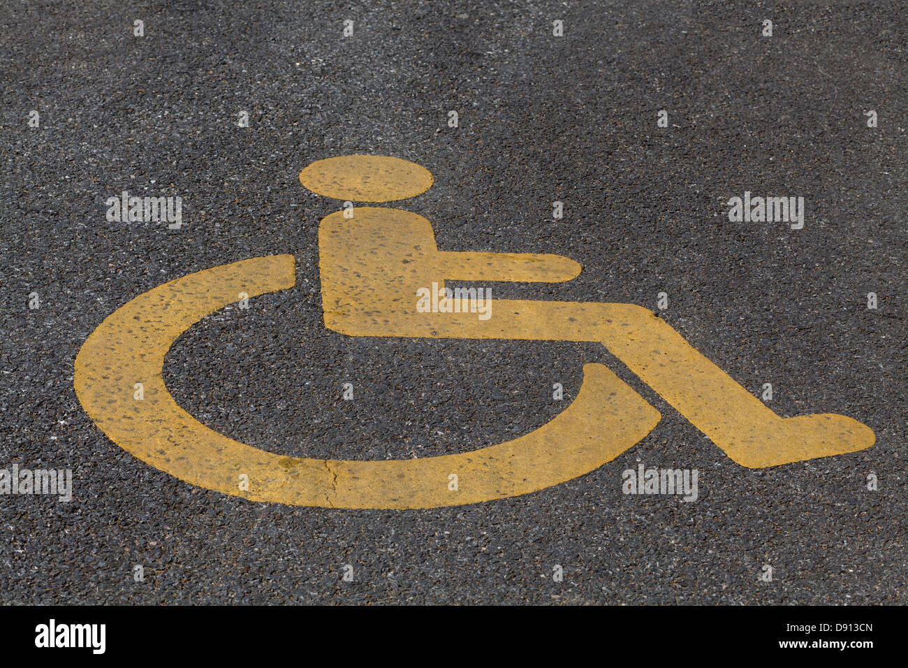 yellow wheelchair handicap road sign painted on a pavement Stock Photo