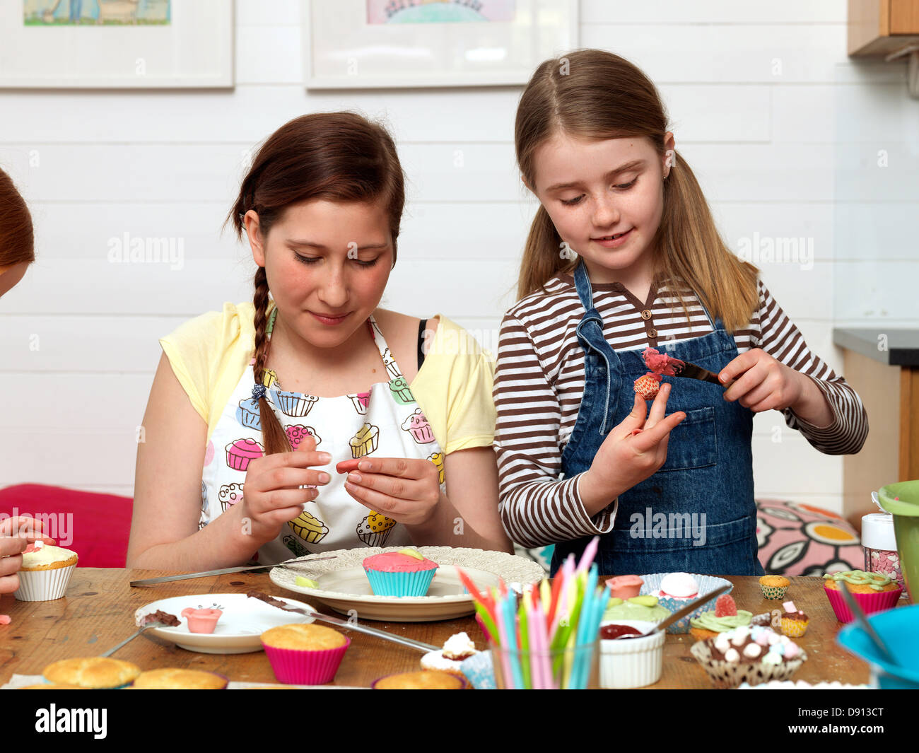Two girls baking cake in kitchen Stock Photo Alamy