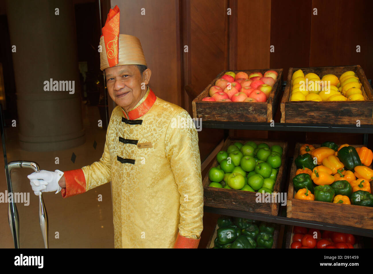 Singapore,Fairmont Singapore,hotel,lobby,doorman,uniform,Asian man men male,employee worker workers working staff,produce,fruit,for sale,Sing130201068 Stock Photo