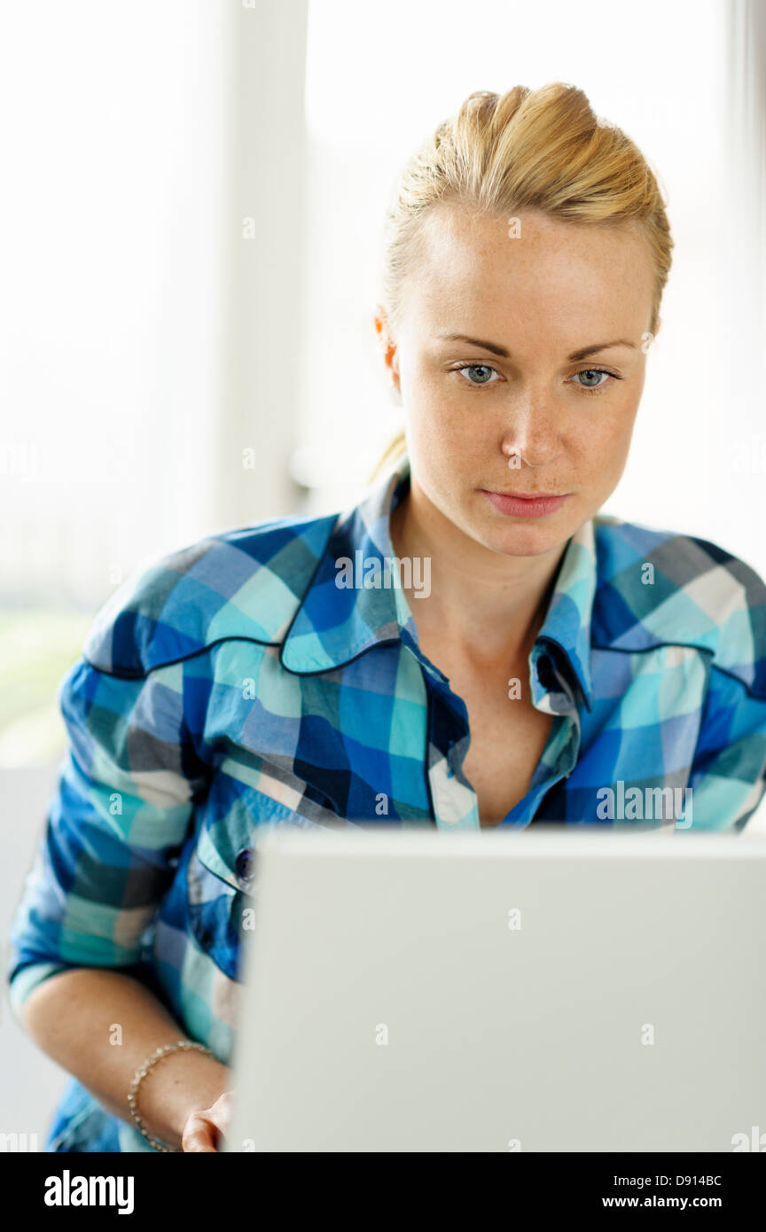 Young woman working on laptop Stock Photo - Alamy