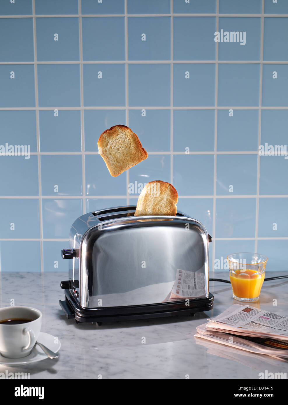 Toasted bread coming out of toaster in domestic kitchen Stock Photo