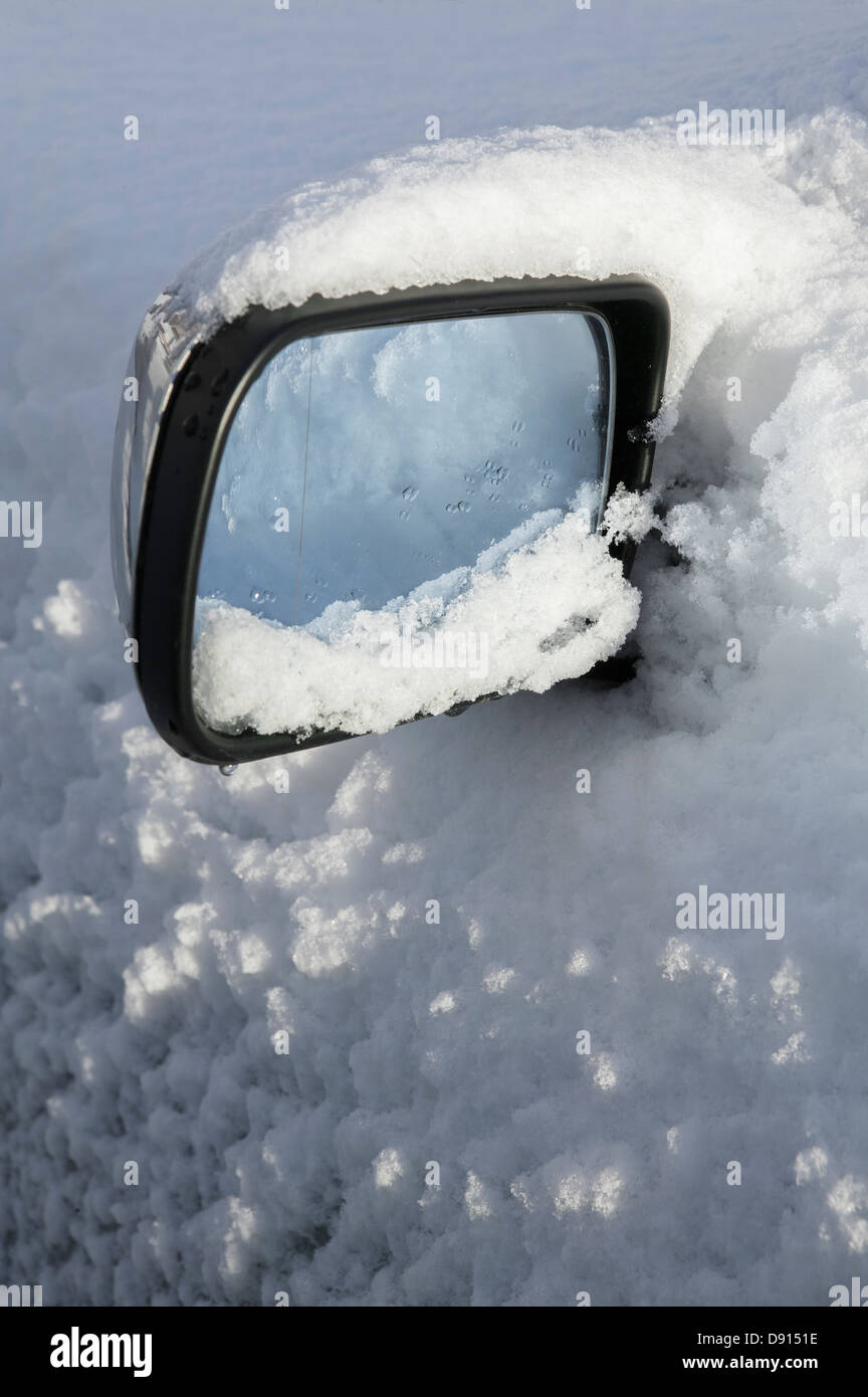 Close-up of wing mirror covering by snow Stock Photo