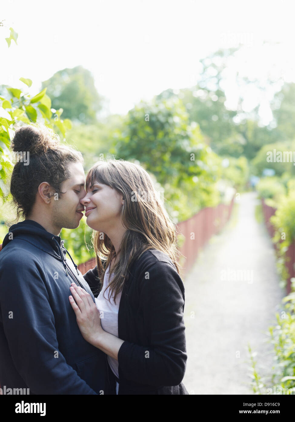 Young couple kissing outdoors Stock Photo - Alamy