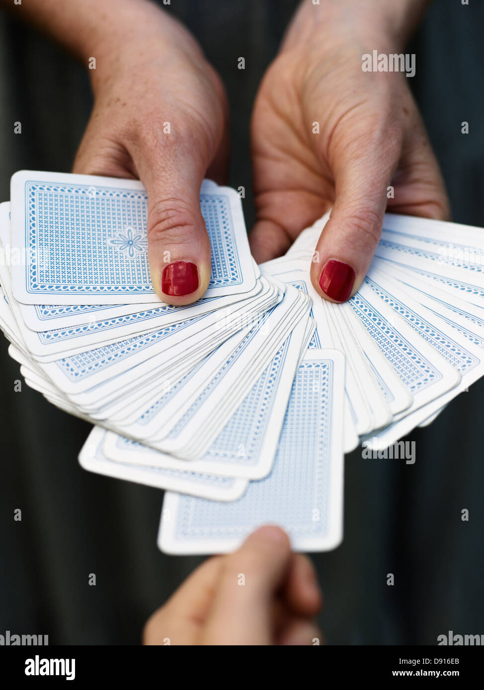 Hands holding fanned out playing cards Stock Photo Alamy