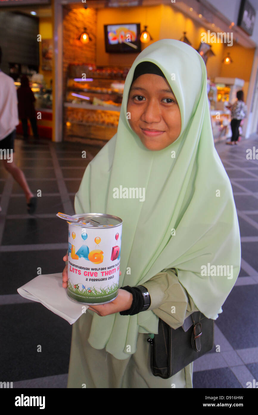 Singapore,Kallang Road,Asian teen teens teenager teenagers girl girls,female kids children Muslim,collecting,donations,charity,welfare home,hijab,Sing Stock Photo