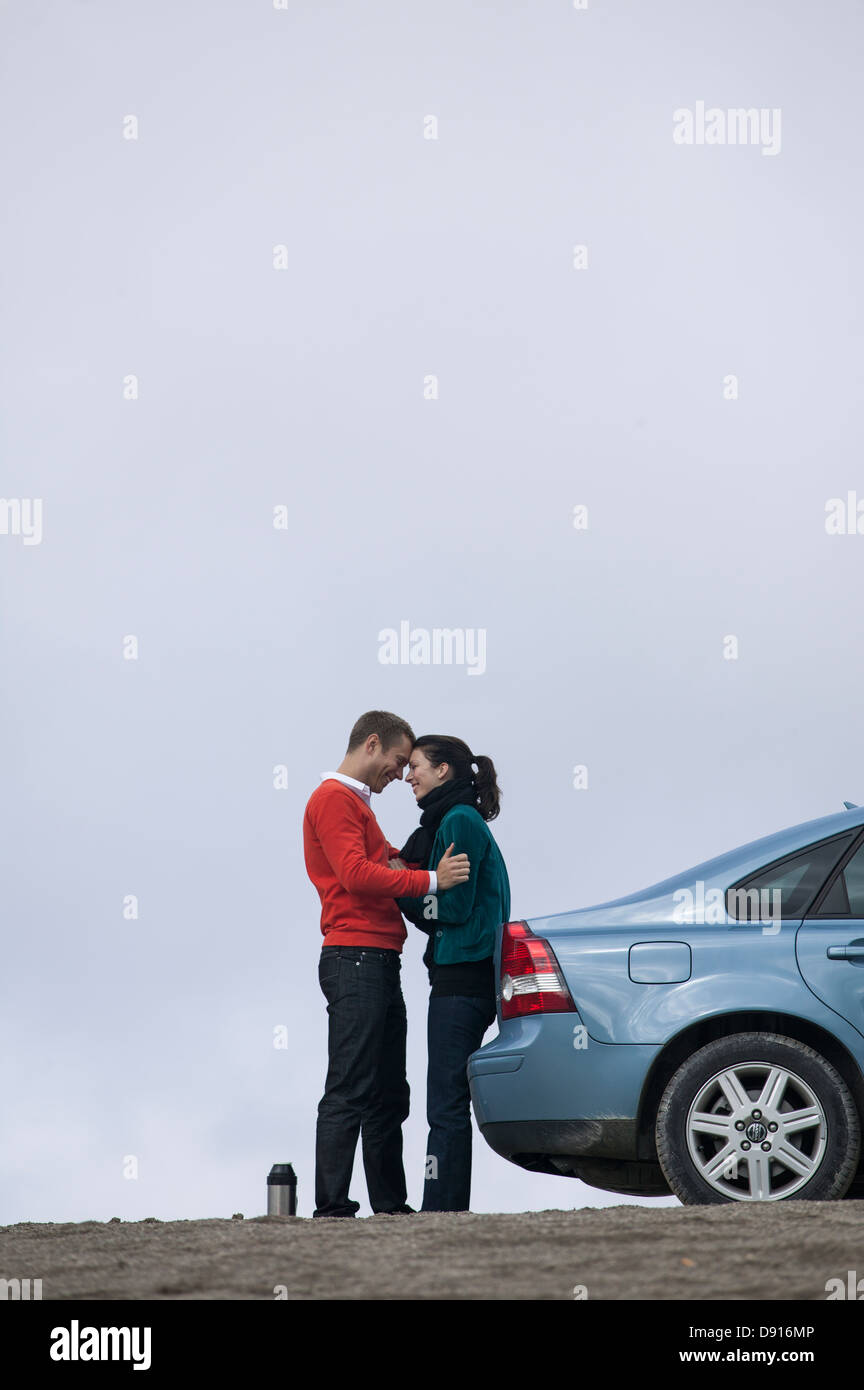 Young couple having break at car trip Stock Photo