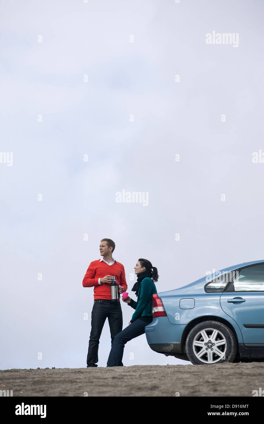 Young couple having break at car trip Stock Photo