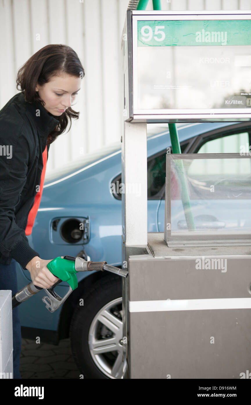 Woman filling car with petrol Stock Photo