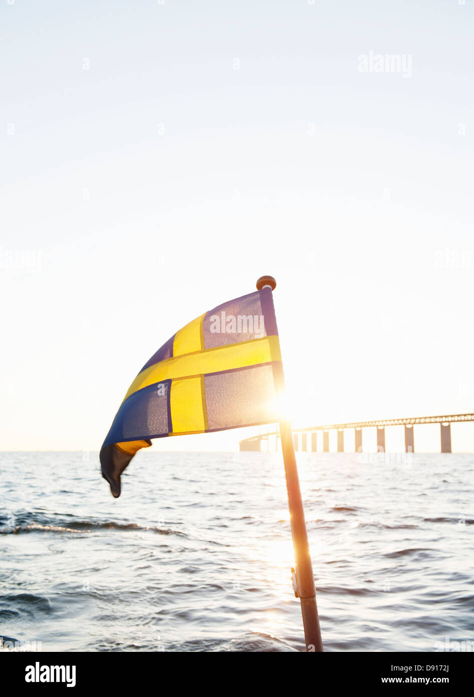 Swedish flag with Oresund bridge in background Stock Photo