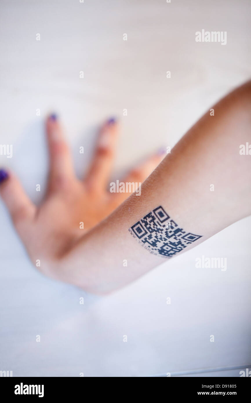 Teenagers arm with QR code tattoo Stock Photo