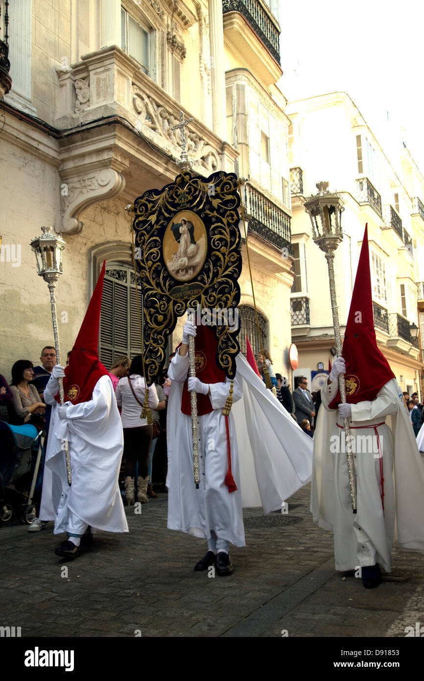 Processions in the streets with traditional costumes for the Catholic Festival of Semana Santa, Cadiz, Andalucia, Spain. Stock Photo