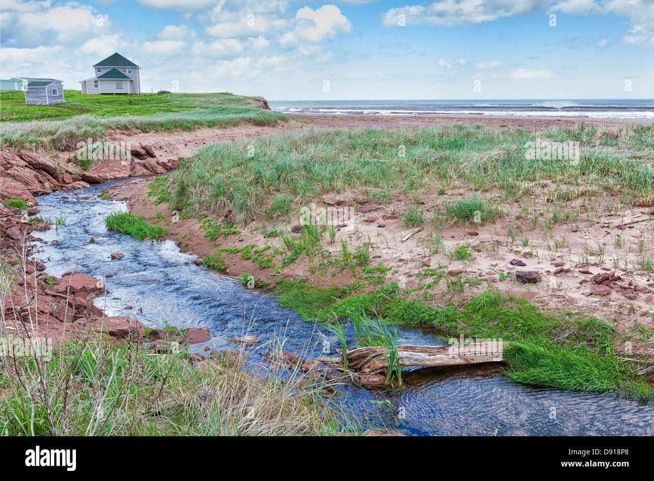 Stream running into the ocean at a north shore beach in rural Prince Edward Island, Canada. Stock Photo