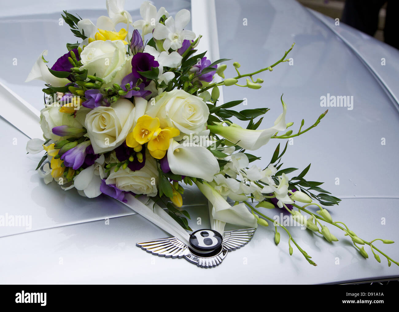 bides bouquet on car bonnet Stock Photo