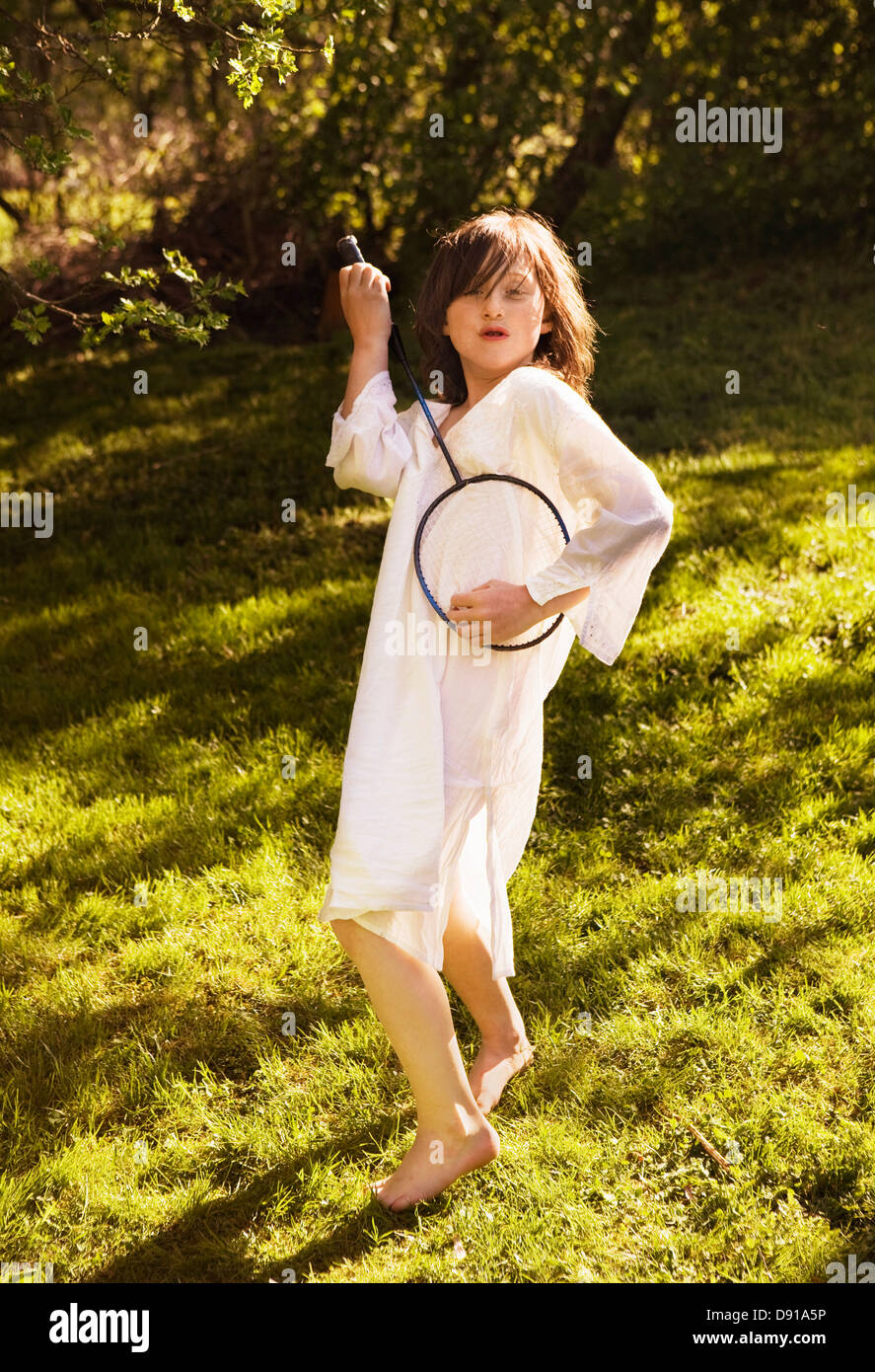 A girl with a badminton bat in the grass, Sweden. Stock Photo