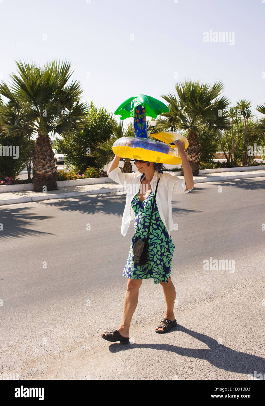 A woman carrying a bathing ring on her head, Greece Stock Photo Alamy
