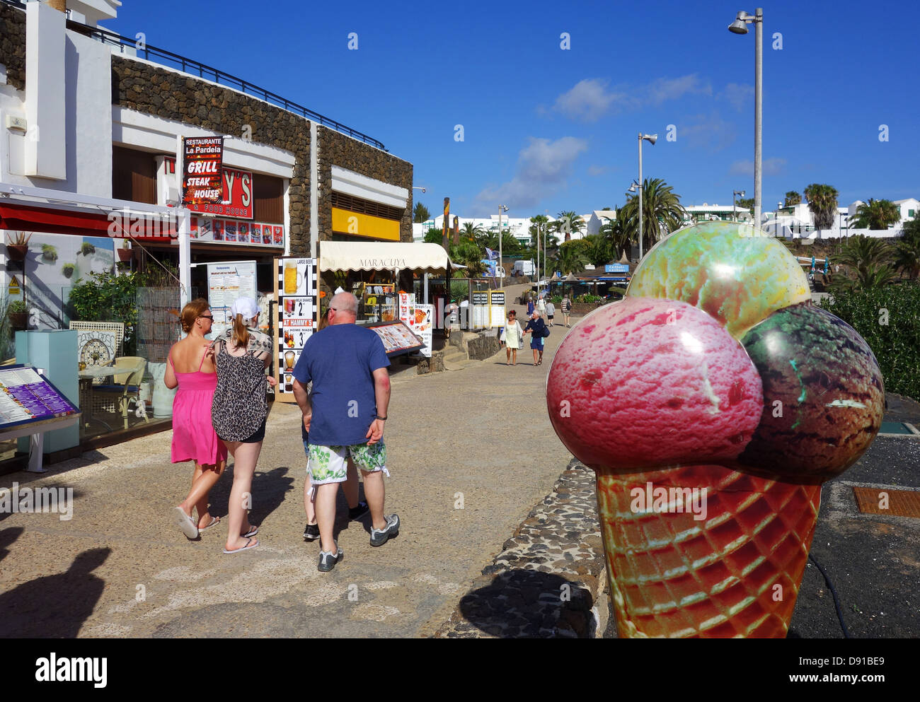 Beachfront shops and cafes by the beach of Playa de las Cucharas, Costa Teguise, Lanzarote, Canary Islands Stock Photo