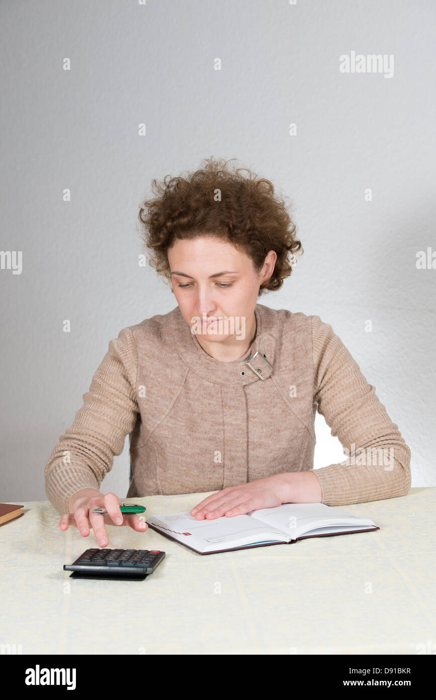 young curly woman works as bookkeeper (accountant) Stock Photo