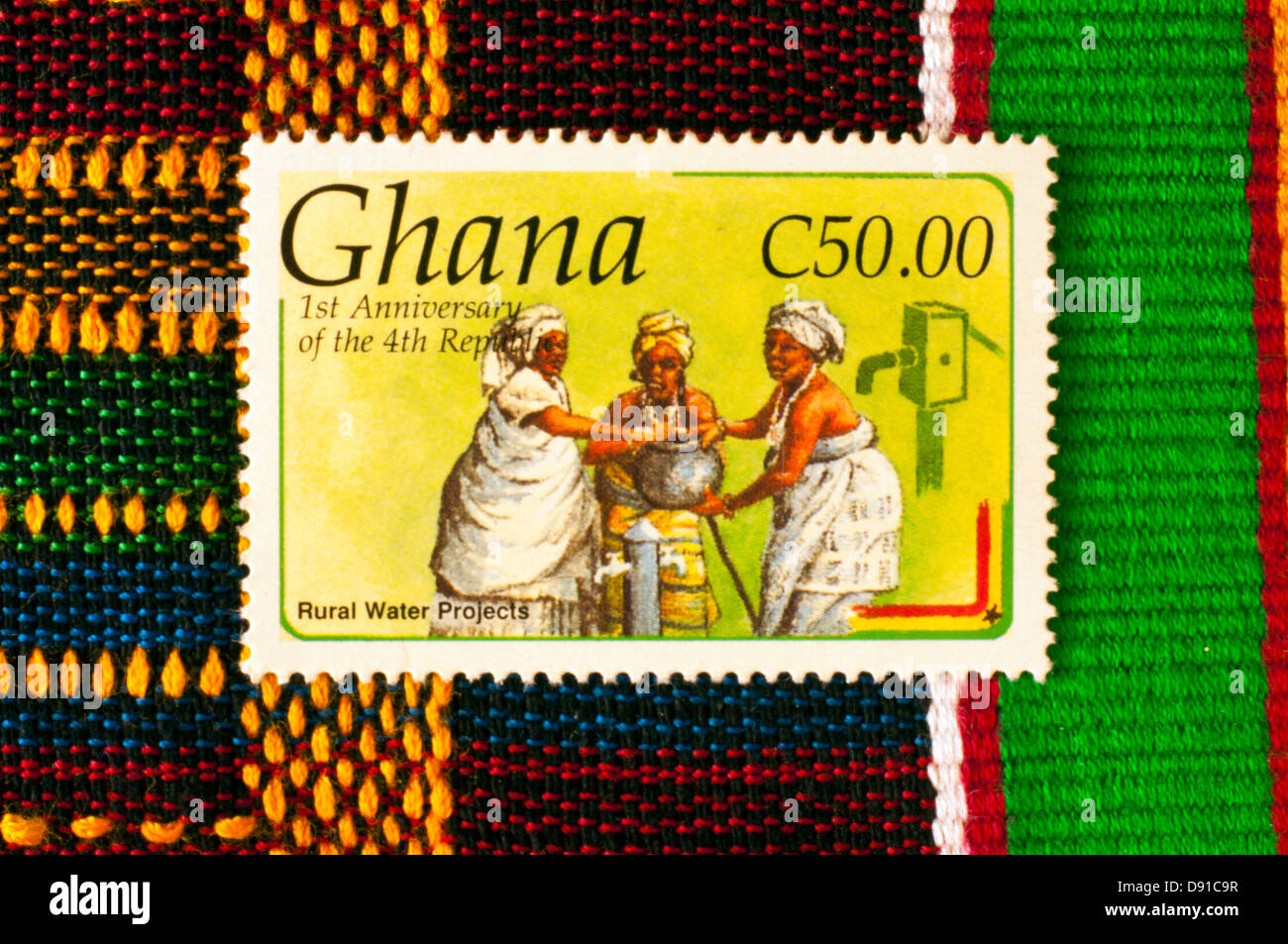 postage stamp with kente cloth, ghana, in studio setting Stock Photo