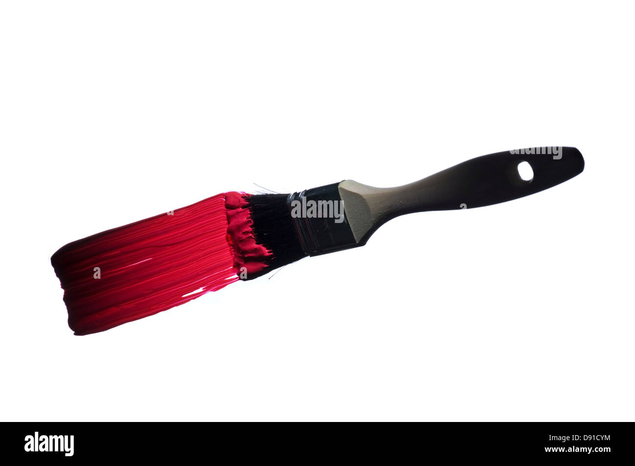 Paintbrush with red paint against white background Stock Photo