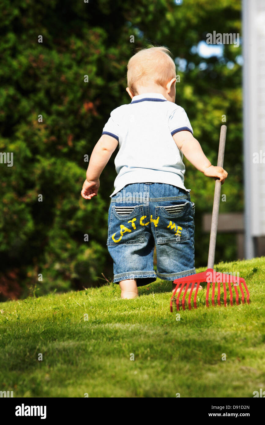Boy with a rake, Sweden Stock Photo - Alamy