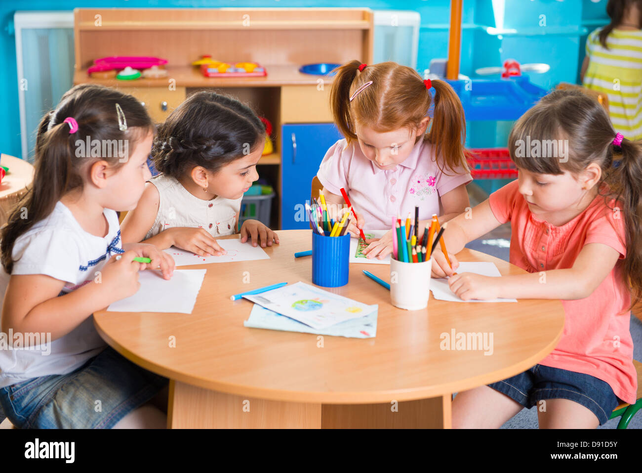 Group of cute little preschool kids drawing with colorful pencils Stock ...