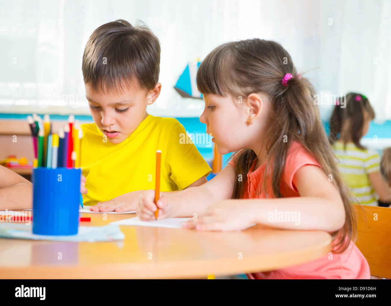 Group of cute little preschool kids drawing with colorful pencils Stock ...